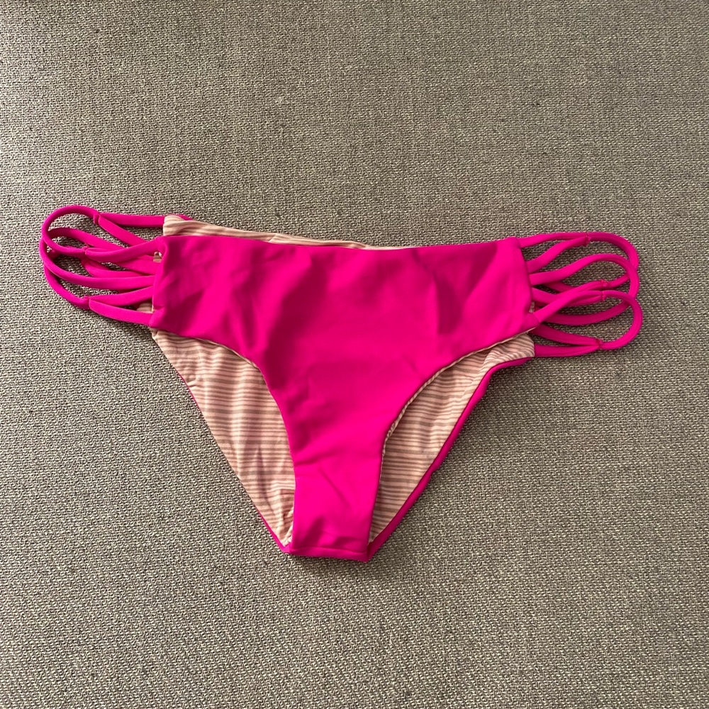 Acacia bright pink swim bottoms with stringy side cutout